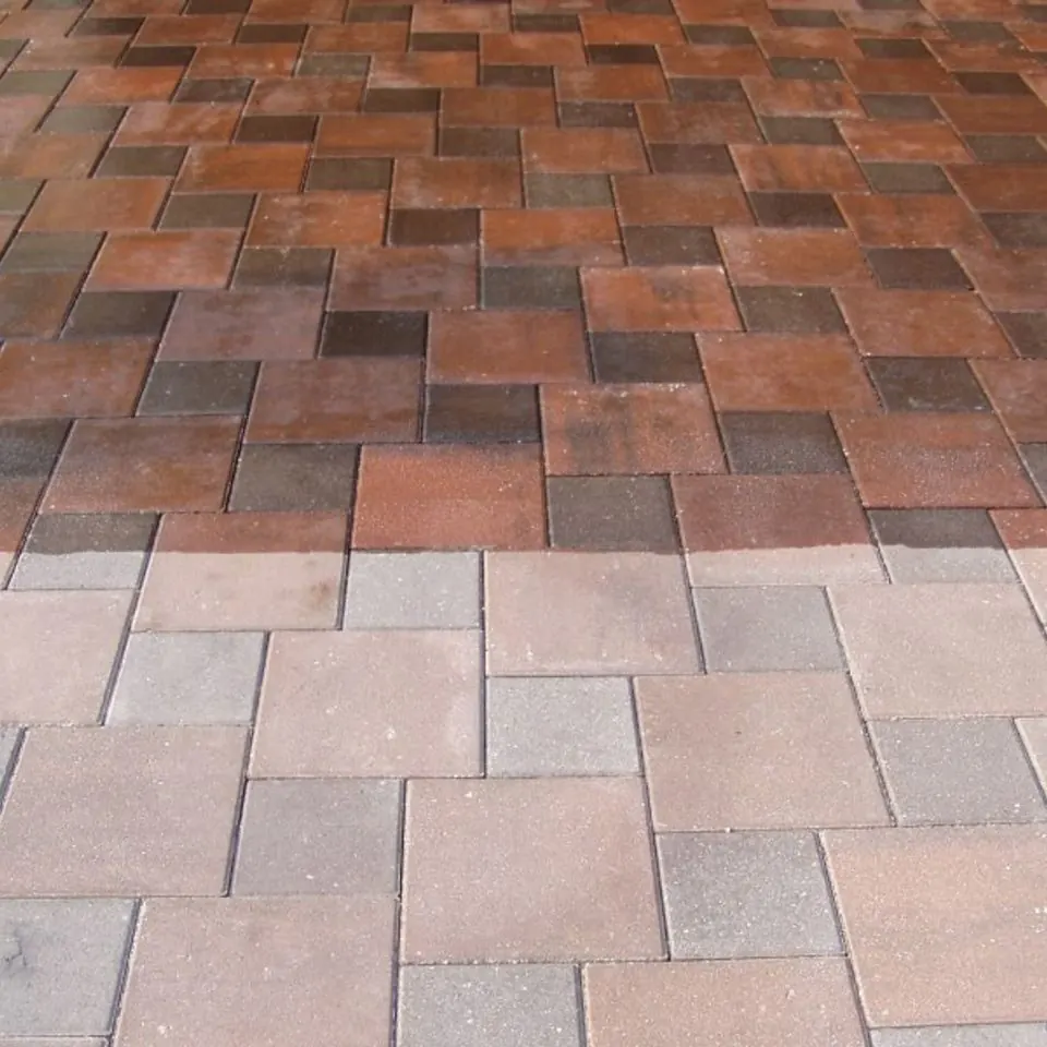 Paver surface half finished with a wet-look sealer, deepening the colour of the treated area
