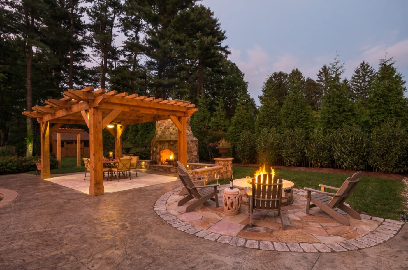 Outdoor fireplace and fire pit built by Carolina Custom Stone and Hardscape