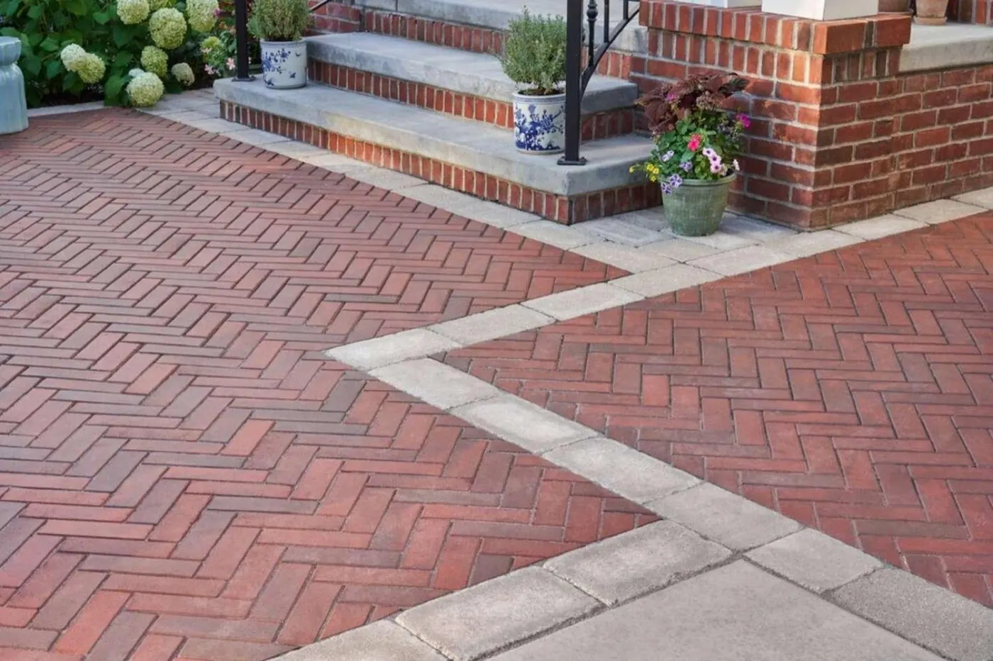 Herringbone brick paving with a contrasting concrete band running to brick front steps in Huntersville