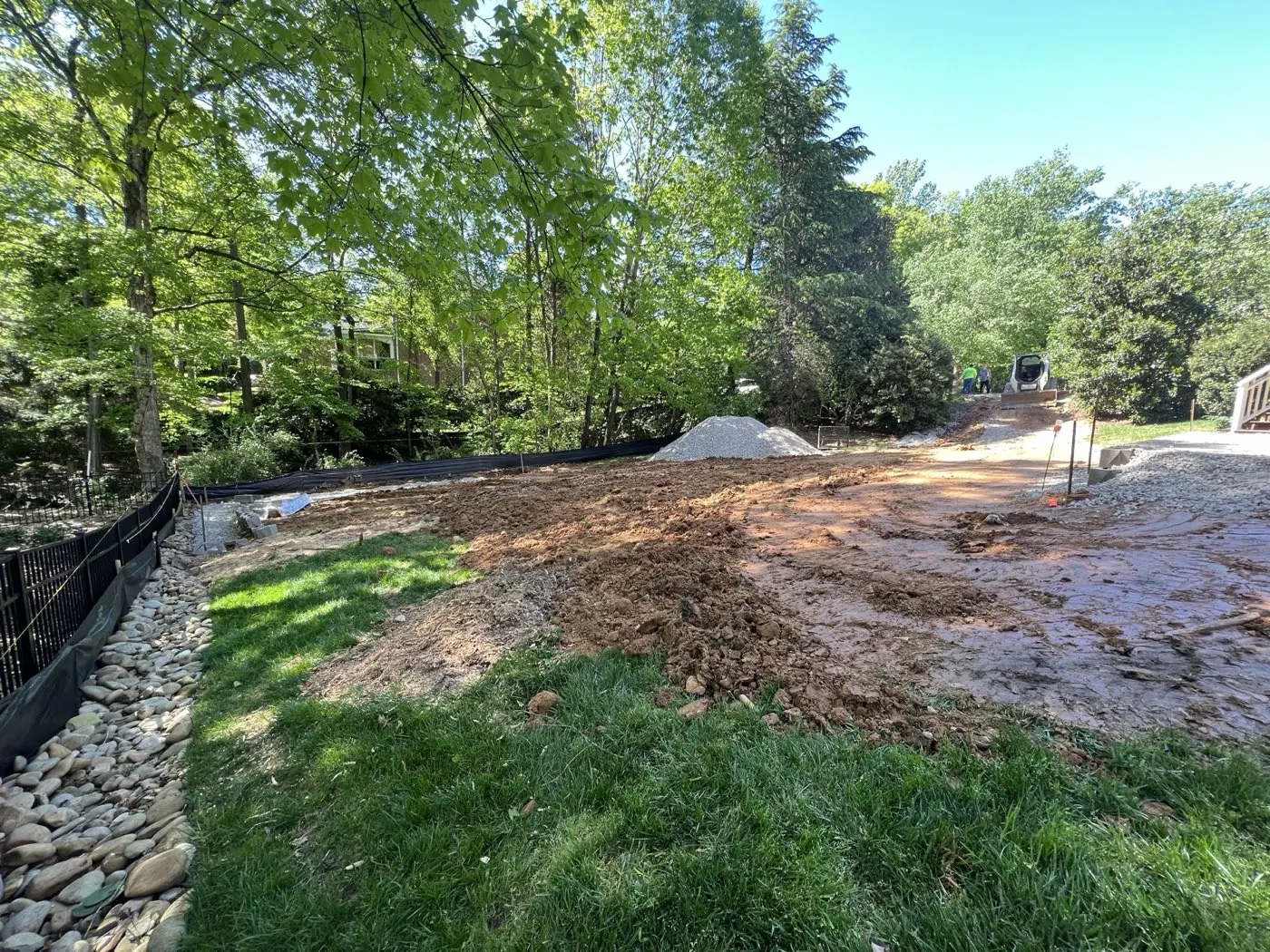 Excavated ground and silt fencing along a new gravel access path