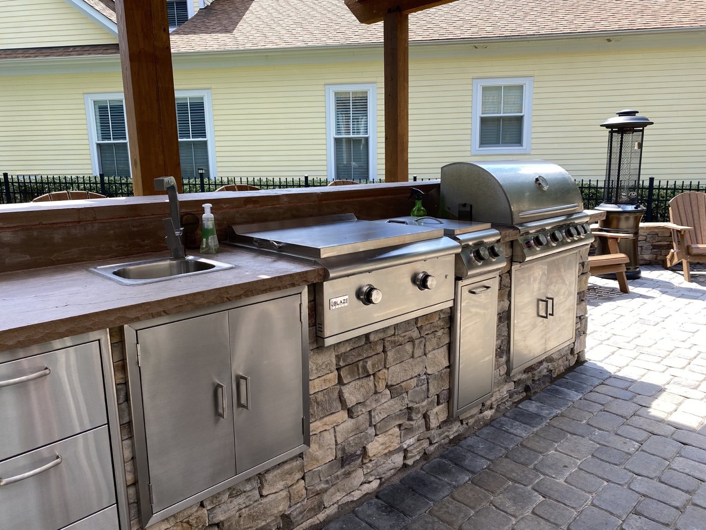 Built-in outdoor kitchen with grill and stone counter