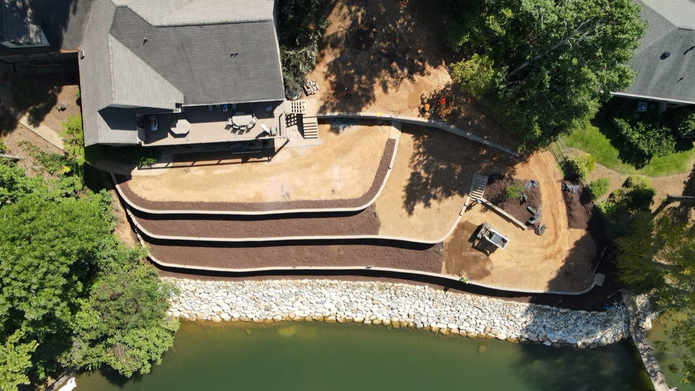 Overhead view of tiered retaining walls following a riprapped Mooresville shoreline