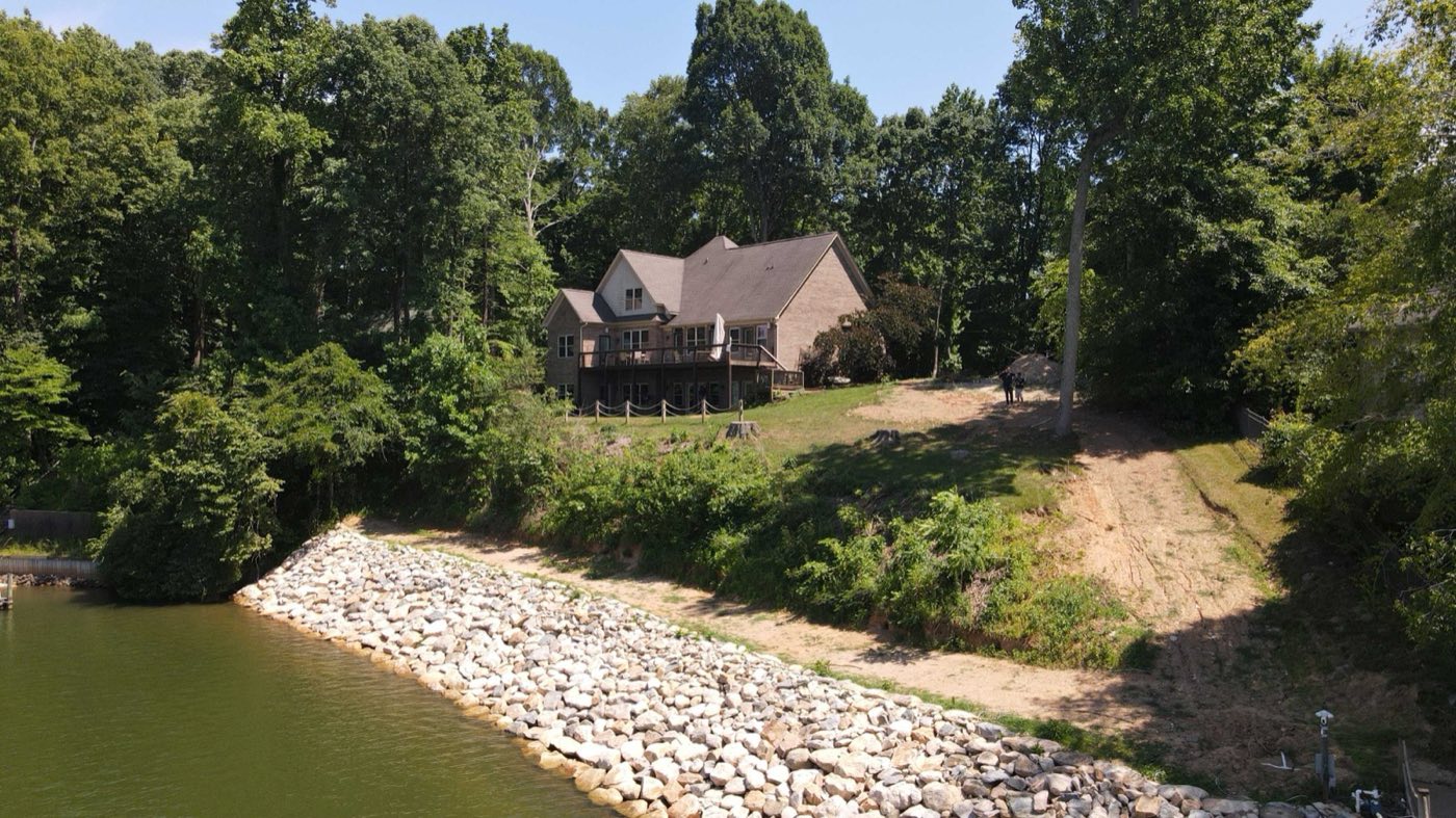 Riprap shoreline stabilising the bank below a lakefront home in Mooresville