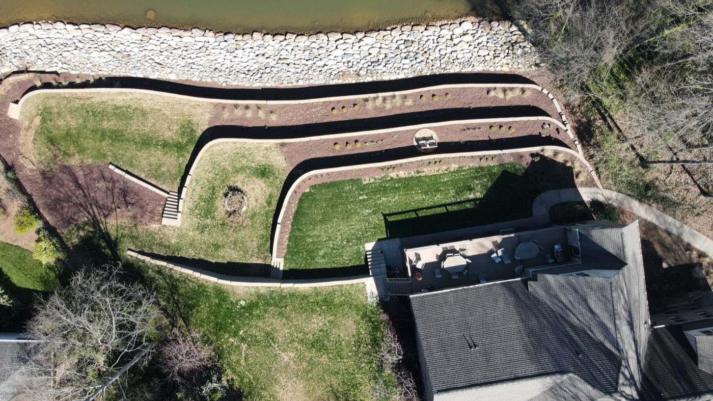 Overhead view of terraced walls carving level lawn out of a steep lakefront slope