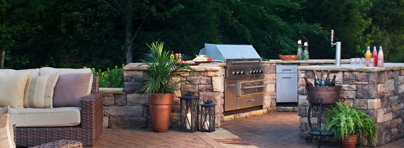 Outdoor kitchen with built-in grill, counter and lighting
