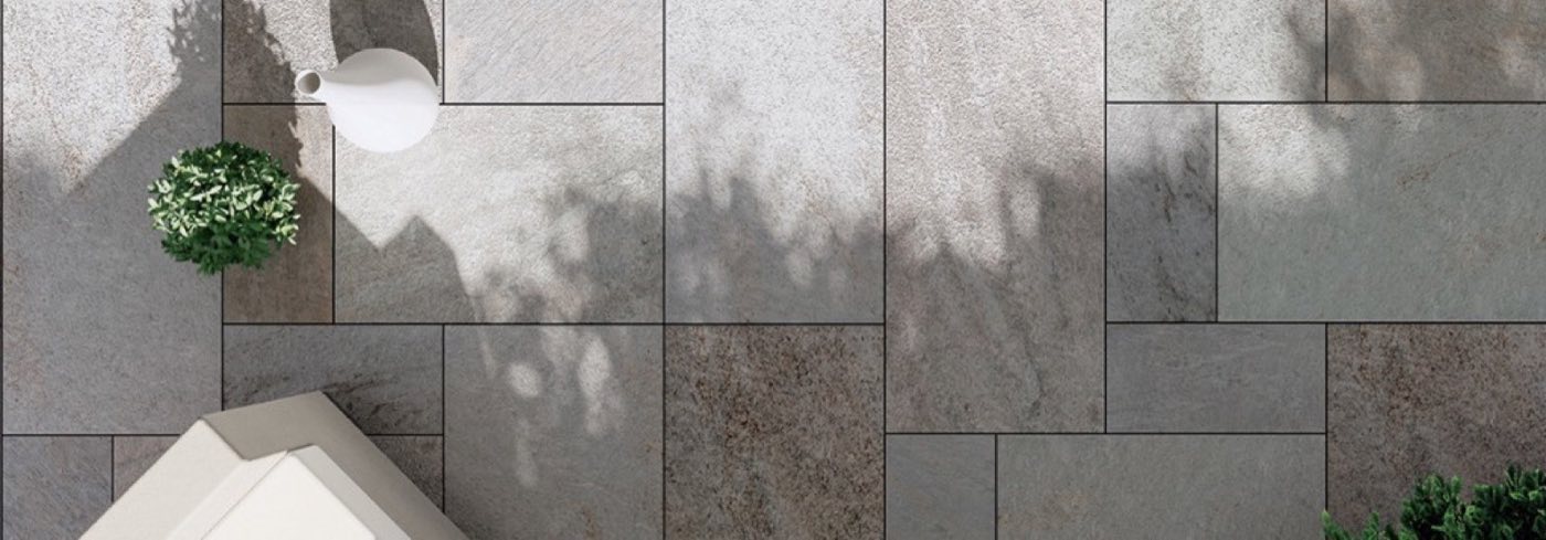 Grey stone-look porcelain pavers laid in a modular pattern